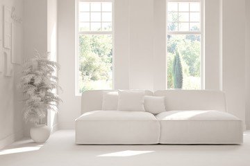 Fototapeta premium Mock up of stylish room in white color with sofa and green landscape in window. Scandinavian interior design. 3D illustration