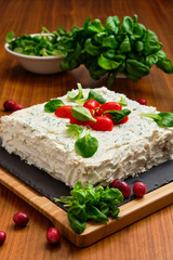 Fototapeta na wymiar Vegan pie with cream cheese, tomato, basil and cranberry
