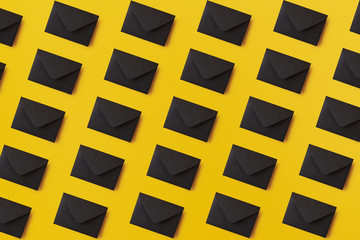 Black envelopes on the yellow background. Mail concept