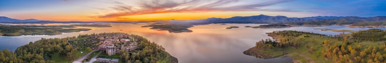 Aerial view of a medieval age scenery at the amazing and abandoned Granadilla town. Impressive medieval castle in between the surrounding defense wall inside an awe fantasy landscape with a moody sky
