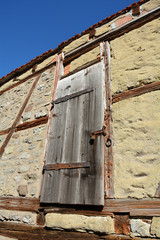 Old wooden door high up on a castle facade