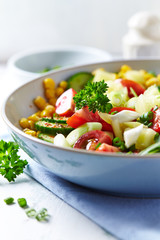 Healthy and tasty salad with cherry tomatoes, cucumber and sweet corn. 