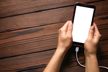 phone with hands addiction on a wooden background
