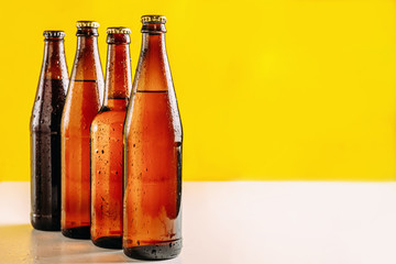 Bottles of beer in different colors. Light and dark beer. Beer background for advertising, chilled...