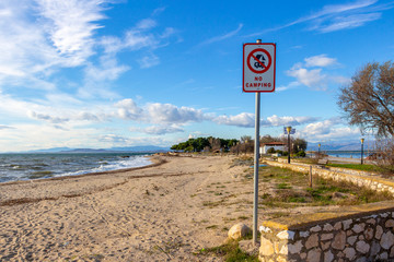No Camping sign at the November off-season coastline of Fanari, Rhodope prefecture, Greece