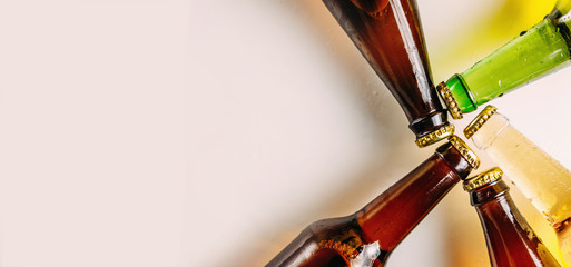Bottles of beer in different colors. Light and dark beer. Beer background for advertising, chilled drink