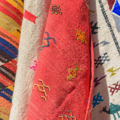 Pieces of fabric and textiles in a factory shop. Multi different colors and patterns on the market.