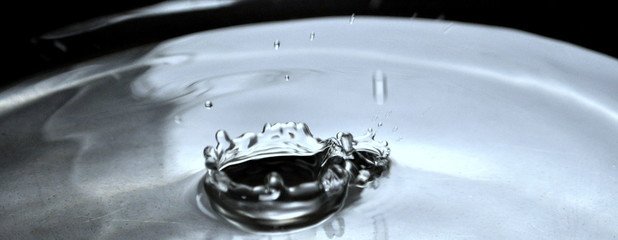 Photo of water pouring splash close up. Water pouring splash background.