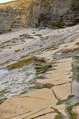 Rocks on Kilve beach near East Quantoxhead in Somerset, England. Stratified layers of rock date back to the Jurassic era and are a paradise for fossil hunters.