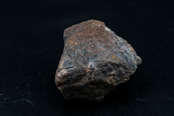 Fototapeta premium Chondrite Meteorite L6W2 Type isolated, piece of rock formed as an asteroid in the universe at during Solar System creation. The meteorite comes from an asteroid fall impacting Earth at Atacama Desert