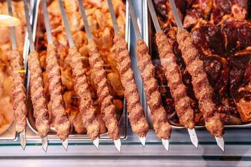 Raw meat for barbecue and kebab on a store window. Spiced meat. Chicken, beef, lamb, minced meat