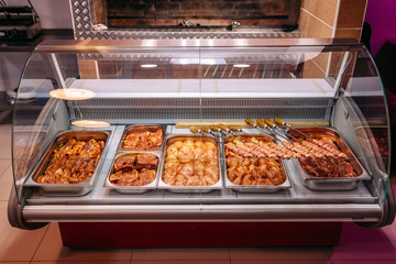 Raw meat for barbecue and kebab on a store window. Spiced meat. Chicken, beef, lamb, minced meat