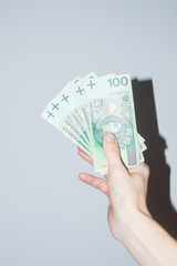 100 PLN banknotes held in hand.