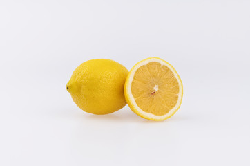 Fresh whole yellow lemon its slices isolated on the white background