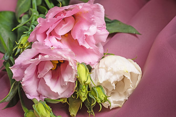 Floral holiday background of eustoma flowers. Buds and flowers of rose without thorns 
