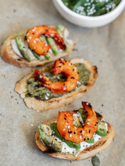 food, sandwiches with shrimp, herbs, yellow cherry tomatoes on a cutting board, serving example