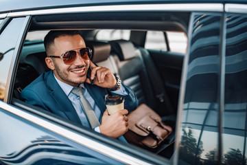 Attractive young businessman in a car