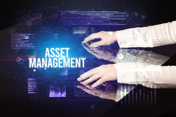 Businessman touching huge screen with ASSET MANAGEMENT inscription, cyber business concept
