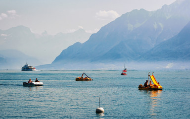 Lausanne, Switzerland - August 26, 2016: People in catamarans on Lake Geneva in Lausanne, Switzerland