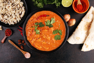 Chicken tikka masala spicy curry meat food in pot with rice and naan bread. indian food