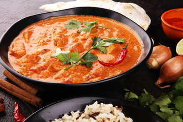 Chicken tikka masala spicy curry meat food in pot with rice and naan bread. indian food