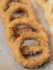 food, squid rings breaded with sauces on a black background, serving example