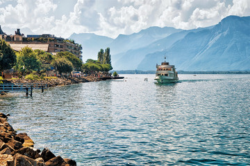 Fototapeta na wymiar Excursion ship with people aboard on Geneva Lake at Montreux, Vaud canton, Switzerland