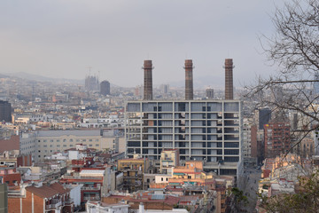 View of New Apartment Building & Three Chimneys with Hazy View over Barcelona 