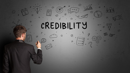 businessman drawing a creative idea sketch with CREDIBILITY inscription, business strategy concept