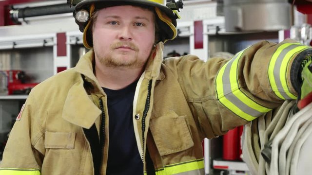 Portrait confident male firefighter in fire station