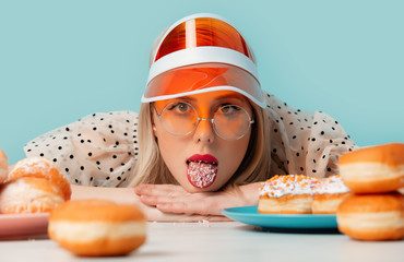 Beautiful woman in 90s clothes with donuts