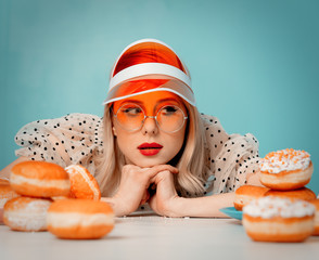 Beautiful woman in 90s clothes with donuts