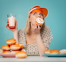 Beautiful woman in 90s clothes with donuts and milk