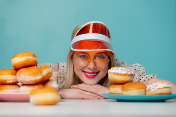 Beautiful woman in 90s clothes with donuts