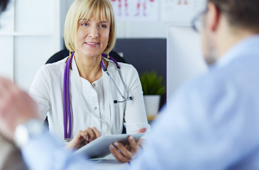 American doctor talking to woman in surgery