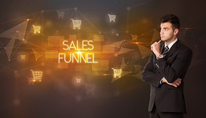 Businessman with shopping cart icons and SALES FUNNEL inscription, online shopping concept