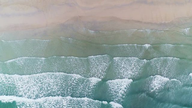 Aerial drone footage of ocean waves reaching shore. Beach on aerial drone top view of Koh Kood is one of Thailand's best island escapes