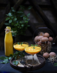 Homemade Egg Liqueur on dark vintage wooden background.