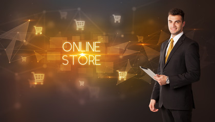 Businessman with shopping cart icons and ONLINE STORE inscription, online shopping concept