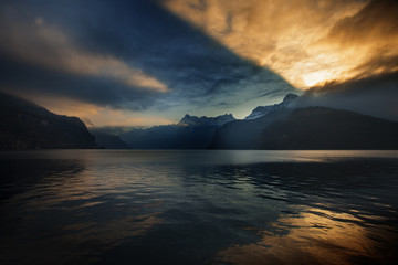 dramatic reflection in the sky and clouds during sunset at lake Lucerne