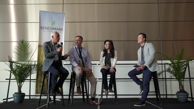 Business People On Panel Speaking On Stage At Conference