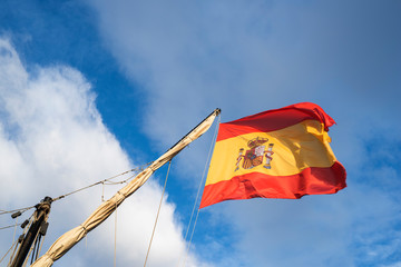 Spanish flag flying above old pirate ship in port of Torrevieja, Alicante, Spain 2019
