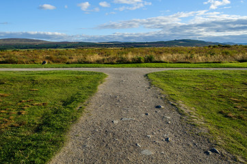 Concept of choice,: footpath forks left or right and is pictures on a summer day at Drummossie Moor near Inverness in the Scottish Highlands, the site of the Battle of Culloden in 1746