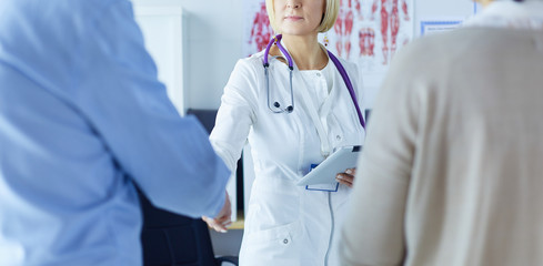 Medical doctor and young couple patients in hospital