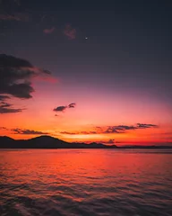 Tuinposter sunset over the sea © Ryan Bates