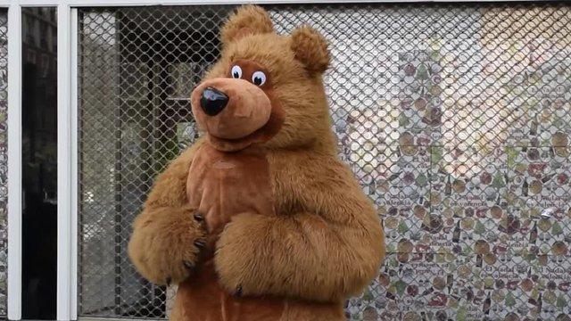 Funny teddy bear dancing in the street