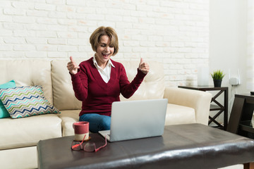 Happy Elderly Woman With Laptop At Home