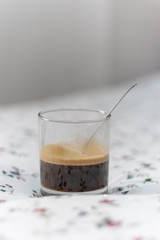 Vertical shot of a black coffee with blurred background