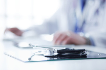 Fototapeta premium Portrait of senior doctor in office sitting at the desk