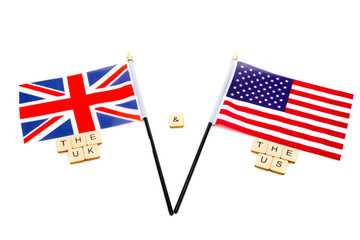The flags of the United Kingdom and the United States isolated on a white background with a sign reading The UK & The US